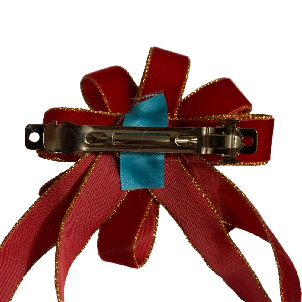 Red ribbon hair clip with a blue center on a white background