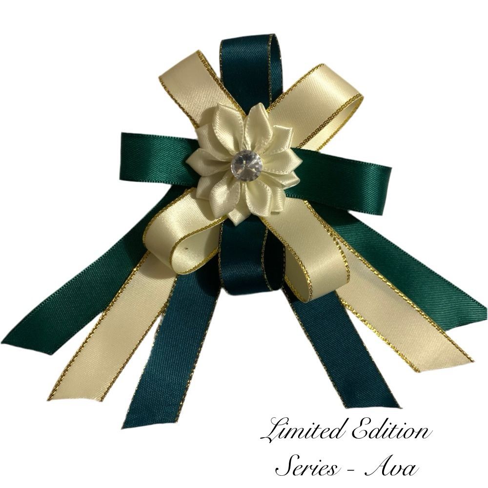 Green and gold bow with a flower and gemstone on a white background