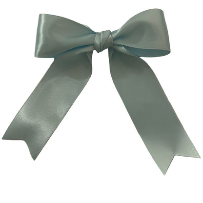 Large light blue satin hair bow on a white background