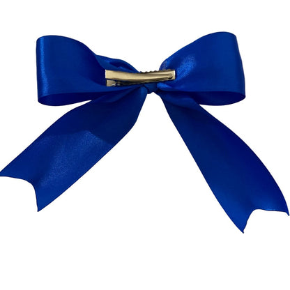 Blue bow with a hair clip on a white background