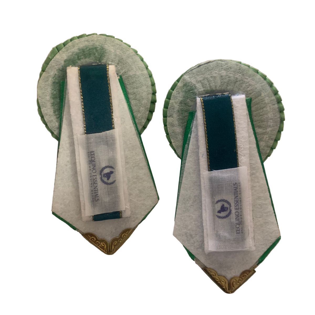 Pair of green removable rosettes with a visible brand label on a white background