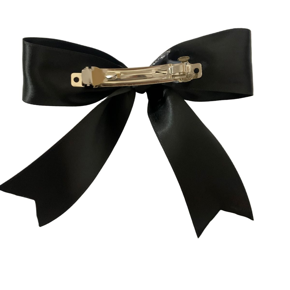 Black bow hair clip with a silver barrette on a white background