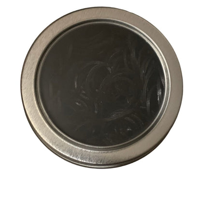 Round tin filled with horse braiding bands on a white background