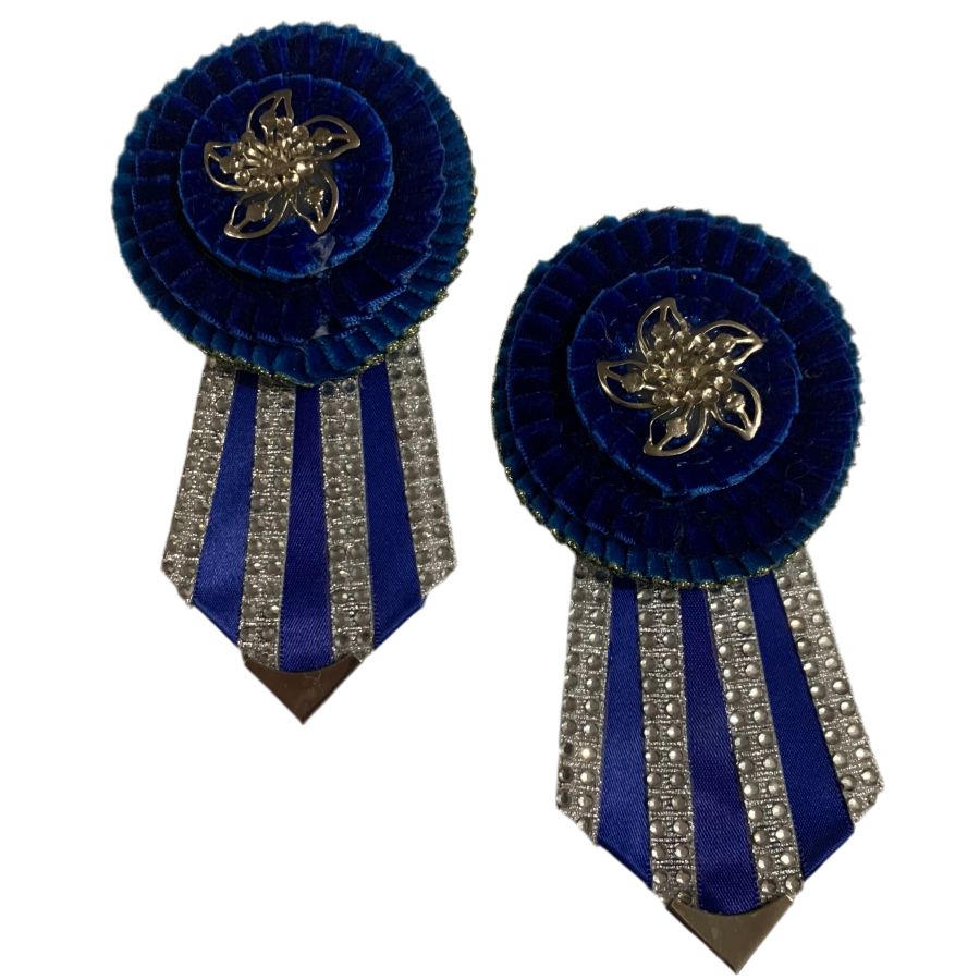 Royal blue removable rosettes with silver crystal flags on a white background