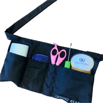 Black apron with various tools and a container on a white background