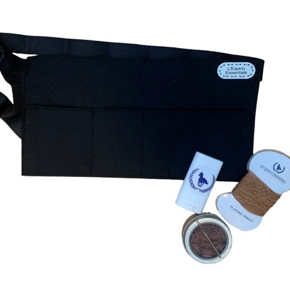 Black braiding apron with grooming products on a white background