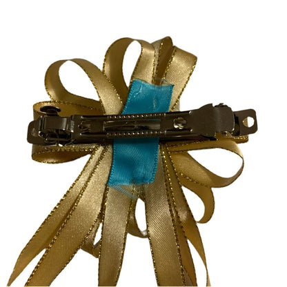 Gold ribbon hair clip with a blue ribbon on a white background