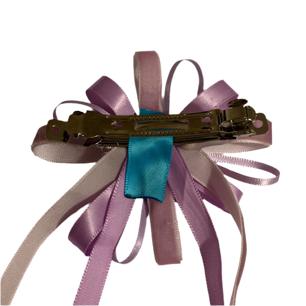 Purple hair bow with silver clip on a white background