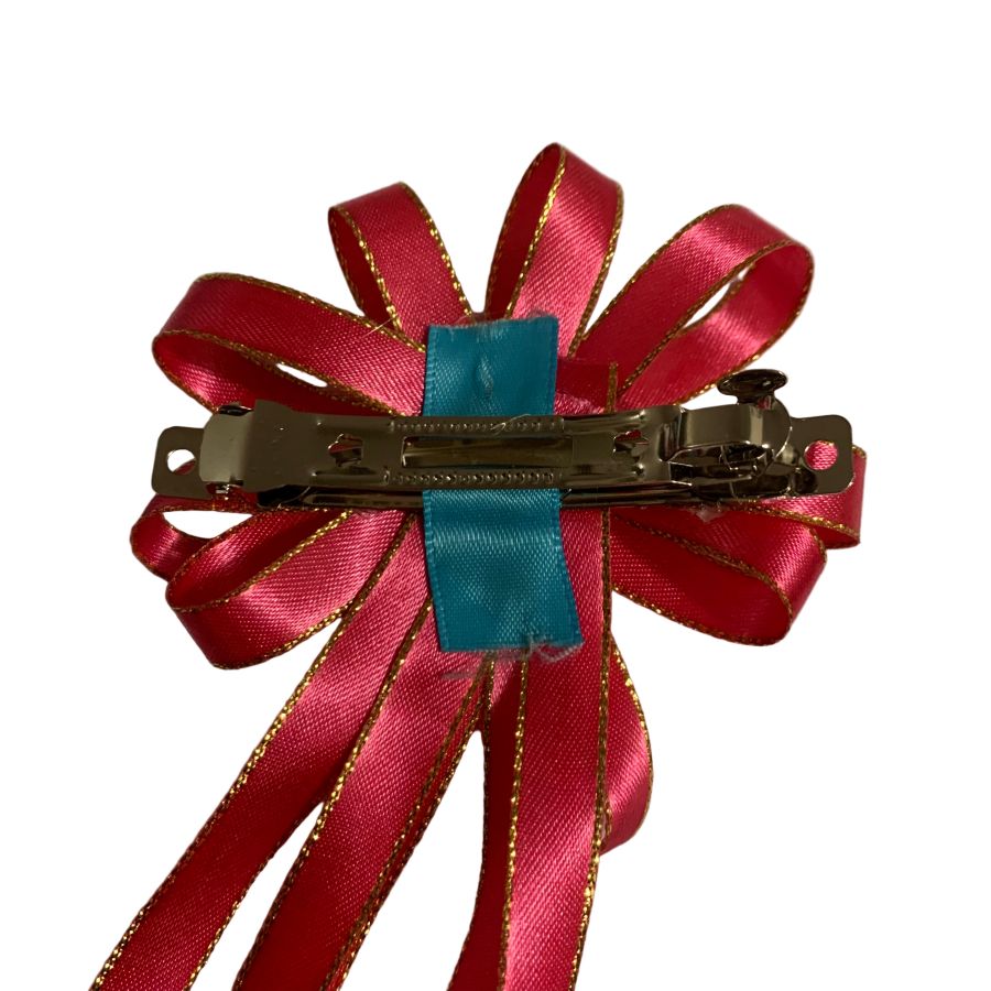 Pink equestrian hair bow with gold accents on a white background