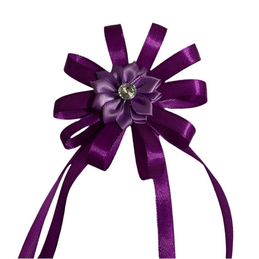 Purple decorative hair bow with a central flower and gemstone on a white background made by L'Equino Essentials