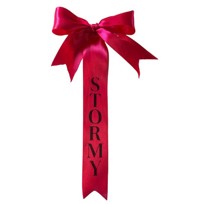 Pink custom tail bows with 'STORMY' text on a white background made by L'Equino Essentials