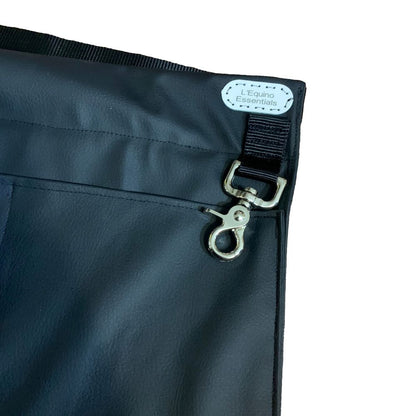 Close-up of a black braiding apron with a metal clasp on a white background