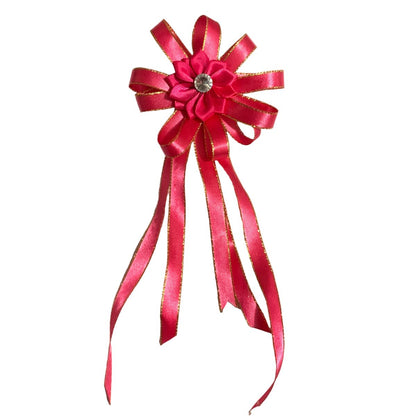 Red decorative hair bow with gold accents on a white background