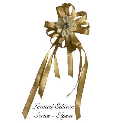 Gold ribbon bow with a flower-like center on a white background, labeled 'Limited Edition Series - Elysia'.