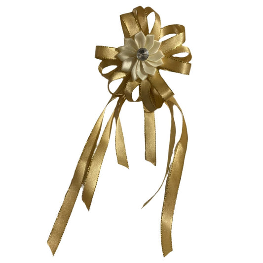 Gold decorative bow with ribbons on a white background