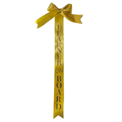 Gold tail bows with learner on board text on a white background made by L'Equino Essentials