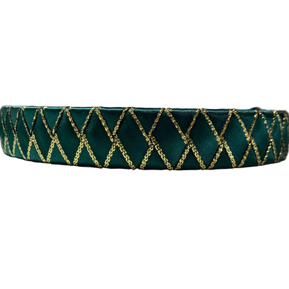 Green satin horse ribbon browband with gold woven pattern on a white background