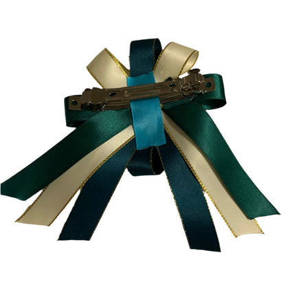 Hair bow with green and beige ribbons and a hair clip on a white background