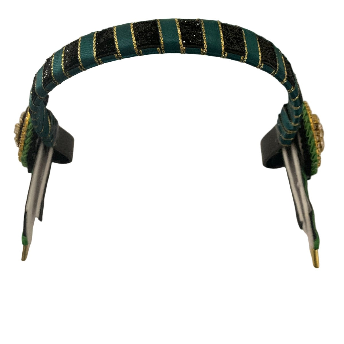 Close-up of a show browband with green and black striped design on a white background