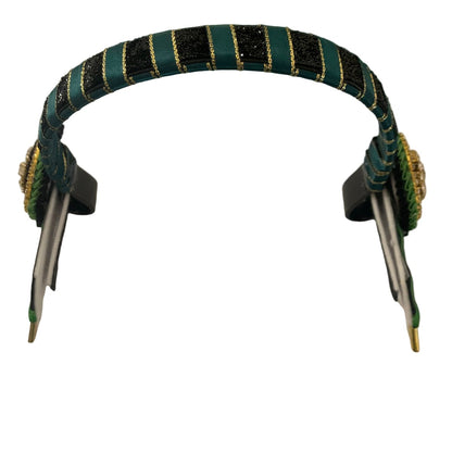 Close-up of a show browband with green and black striped design on a white background
