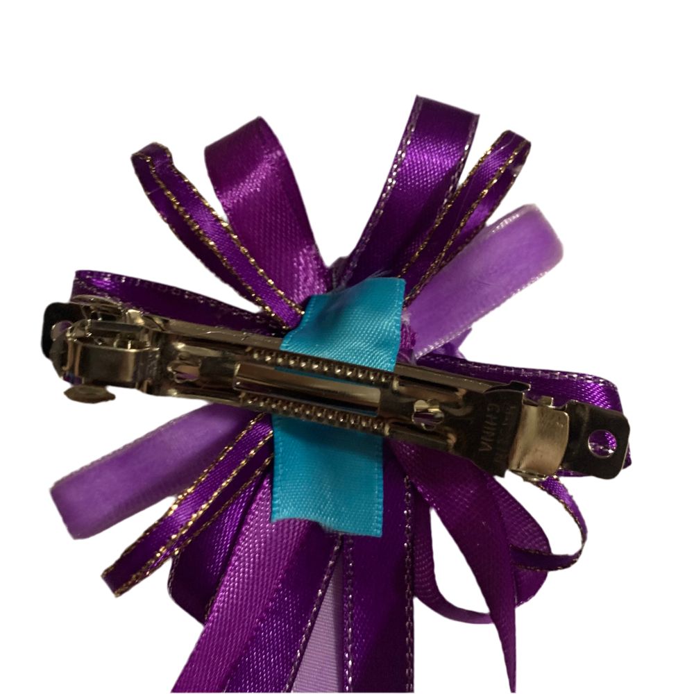 Purple ribbon hair clip on a white background