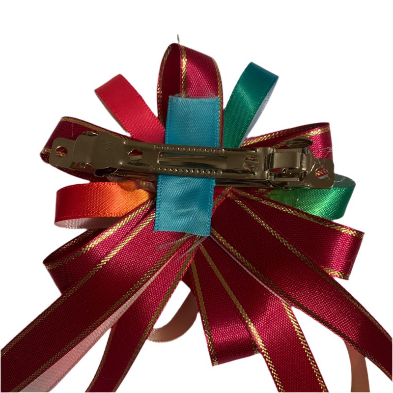 Colorful ribbon hair clip with red, green, and blue ribbons on a white background