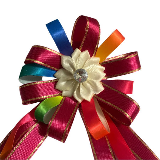 Colorful ribbon hair bow with a decorative flower and gemstone on a white background made by L'Equino Essentials