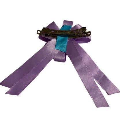 Purple ribbon hair bow with a hair clip on a white background