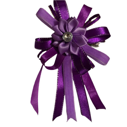 Purple ribbon bow with a central flower and gemstone on a white background made by L'Equino Essentials