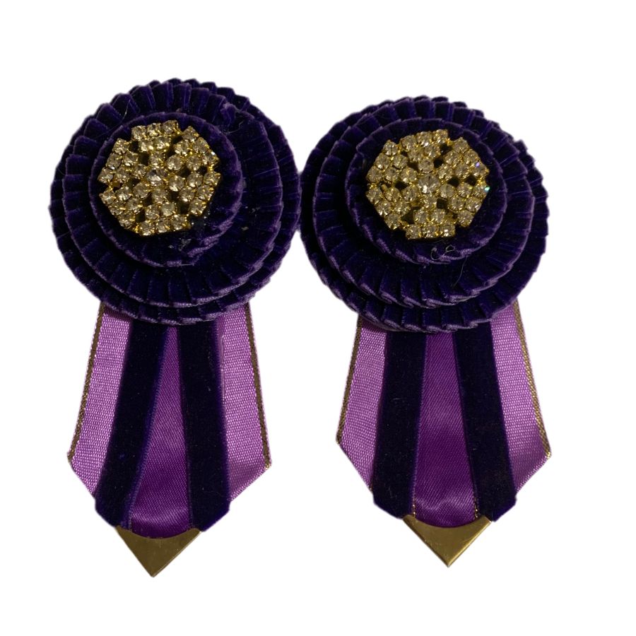 Pair of purple rosettes with gold centers on a white background