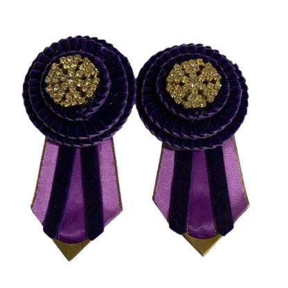 Pair of purple rosettes with gold centers on a white background