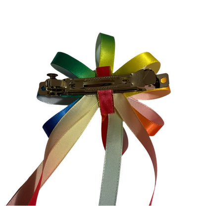Multicolored ribbon hair clip on a white background