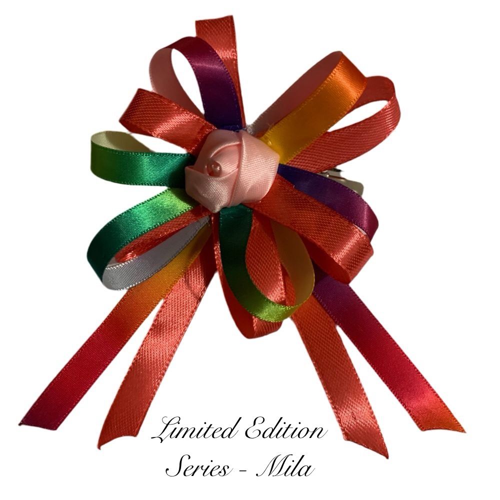 Colorful ribbon bow with a pink rose in the center on a white background, labeled 'Limited Edition Series - Mila'.
