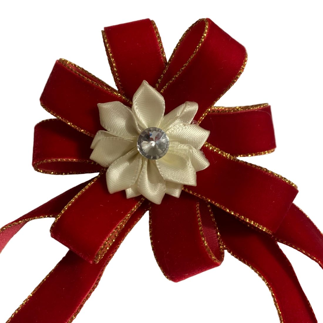 Red bow with a white flower and crystal center on a white background