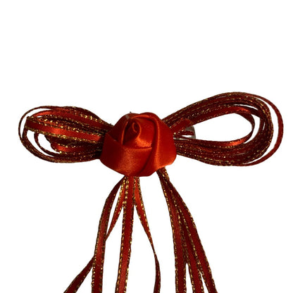 Shiny red bow on a white background