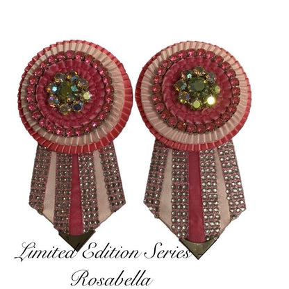 Pair of removable rosettes with pink and gemstones on a white background.