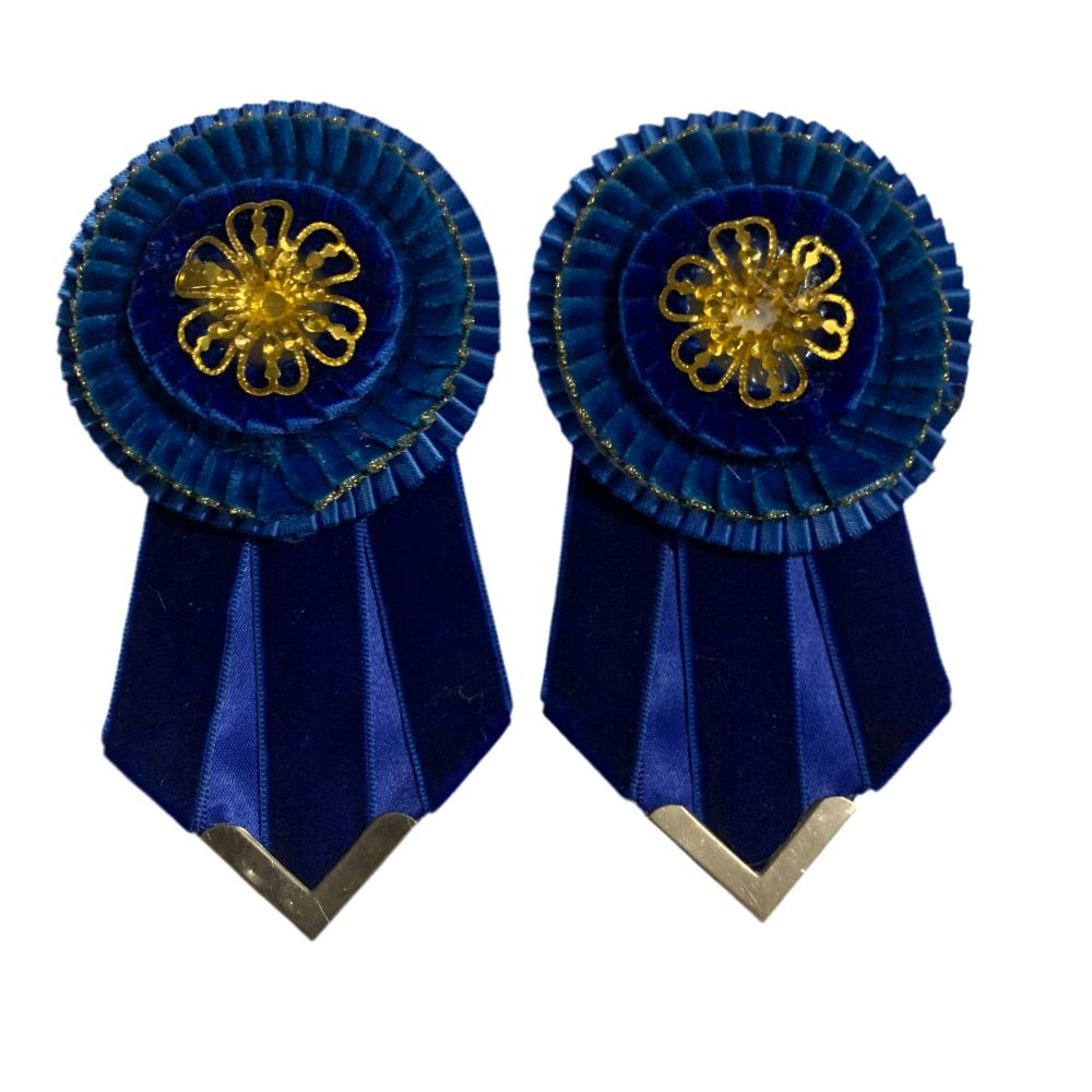 Royal blue removable rosette seconds with gold flower centers on a white background