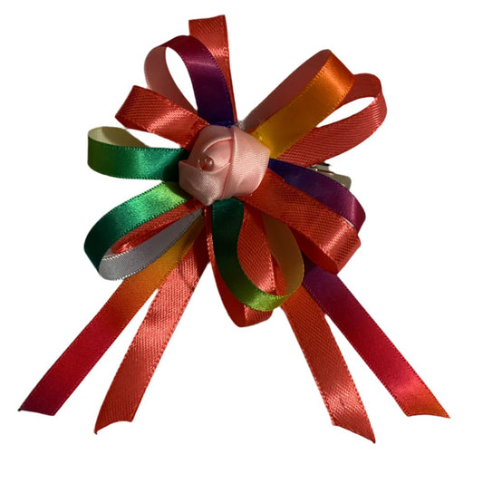 Colorful ribbon hair bow with a small pink flower on a white background