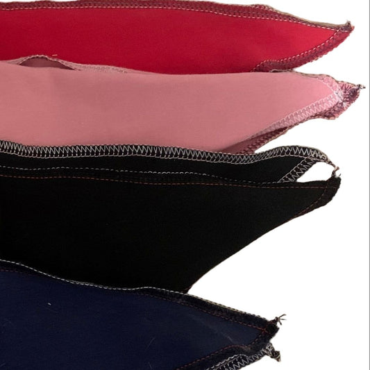Stack of tail bags in red, pink, black, and blue on a white background